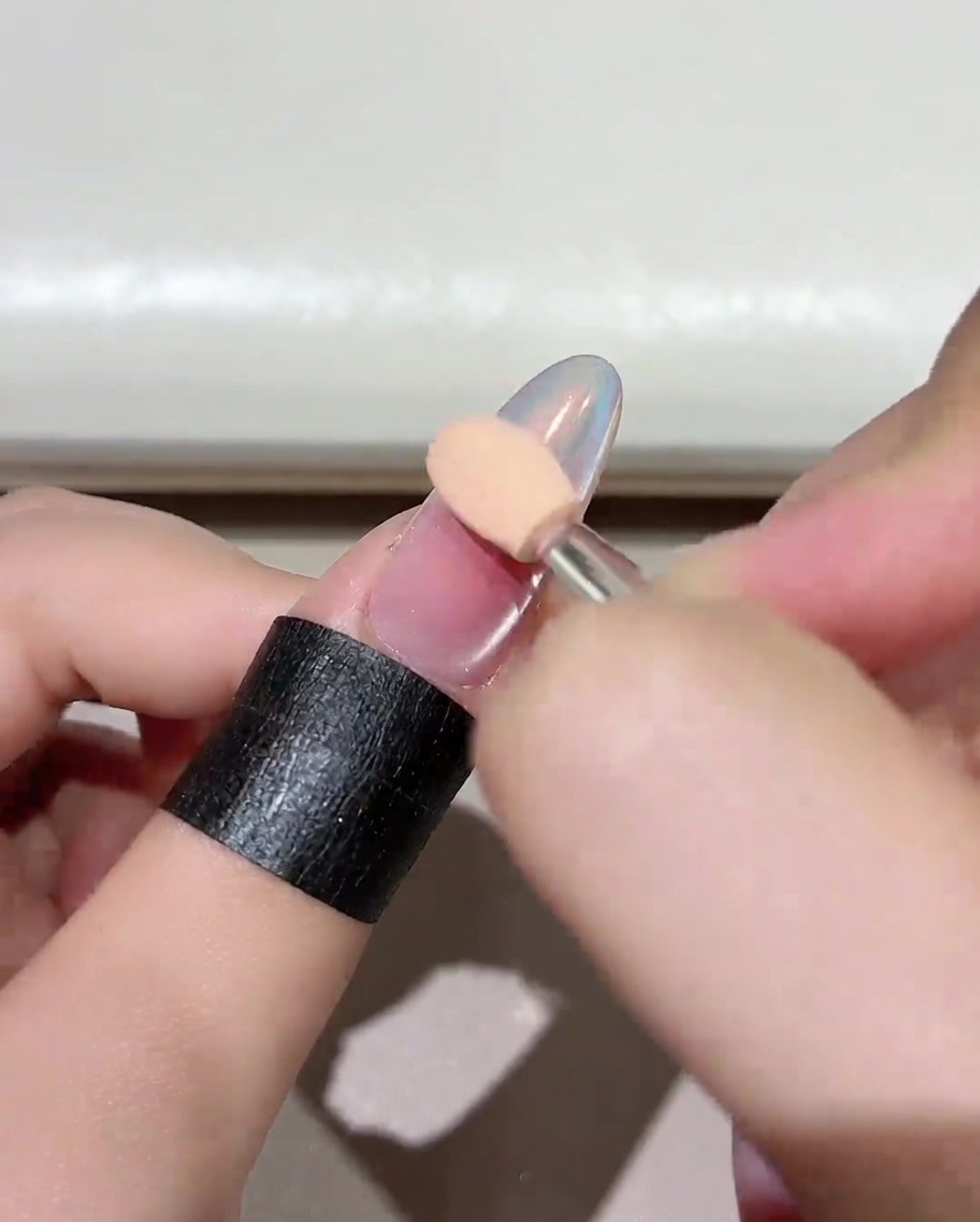 Nahaufnahme eines Fingers unter einer professionellen UV/LED-Nagellampe während des Aushärtungsprozesses.
