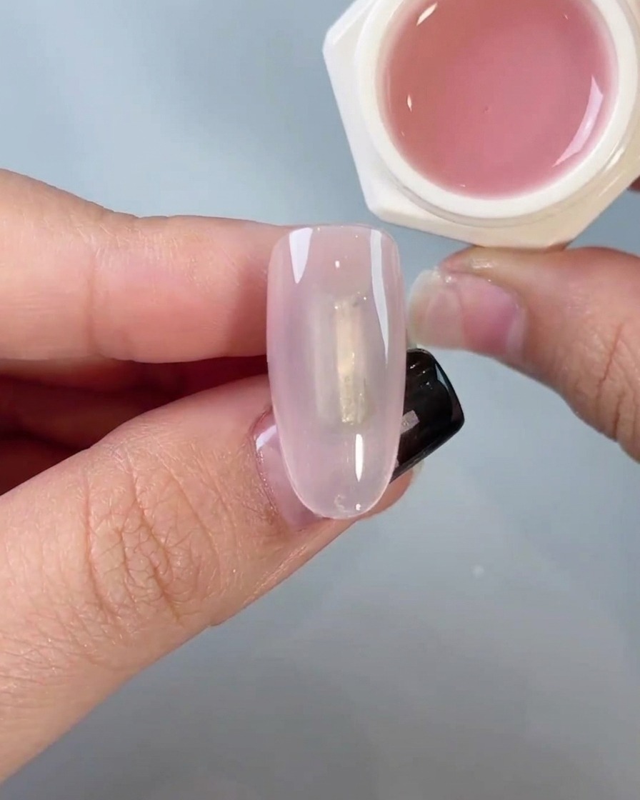 Ein Schwammapplikator reibt sanft Chrome-Puder auf einen Nagel, um ein Spiegel-Finish zu erzielen.