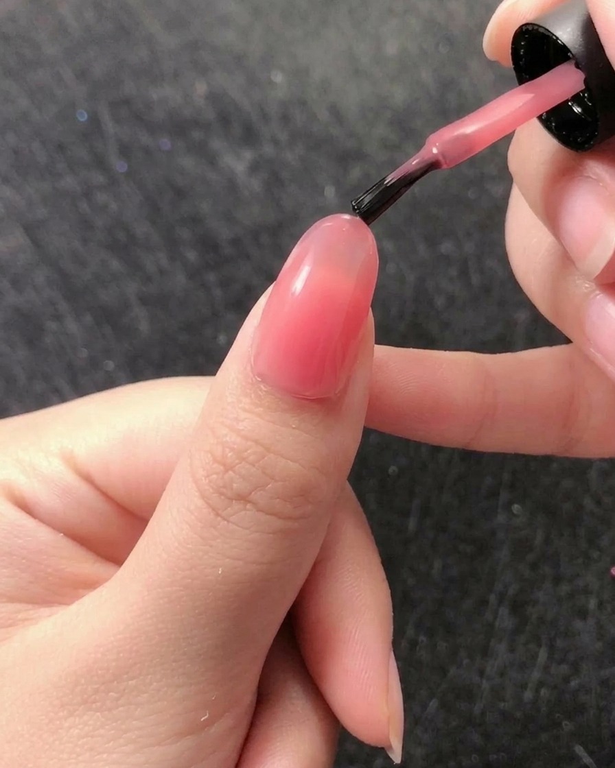 Ein feiner Liner-Pinsel nimmt eine kleine Menge klares Aufbaugel aus dem Tiegel auf.