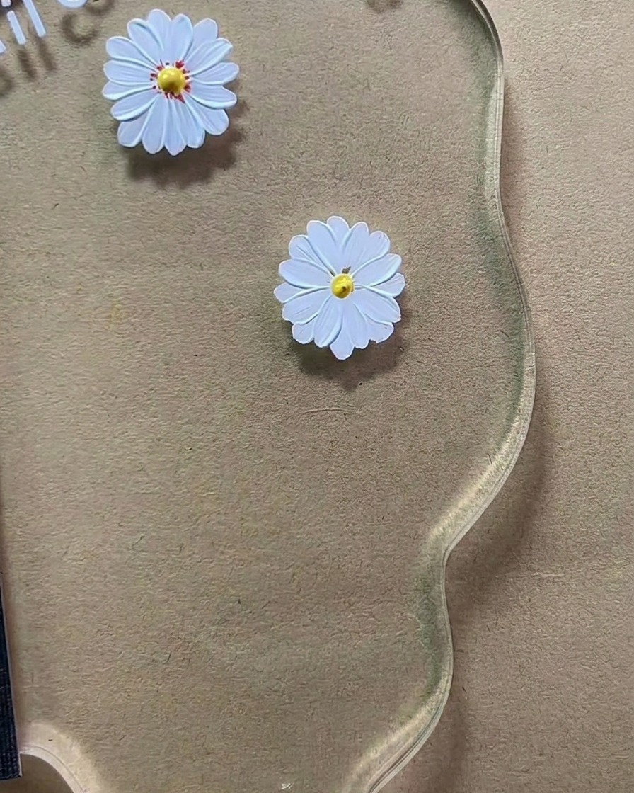 Ein feiner Detailpinsel trägt winzige rotbraune Punkte auf das gelbe Zentrum auf.