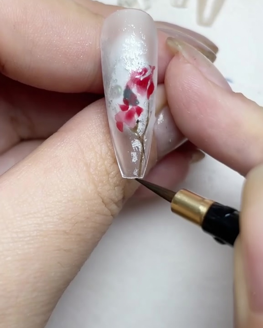 Zeichnen feiner brauner und grüner Stängel und Blätter um das Rosendesign.