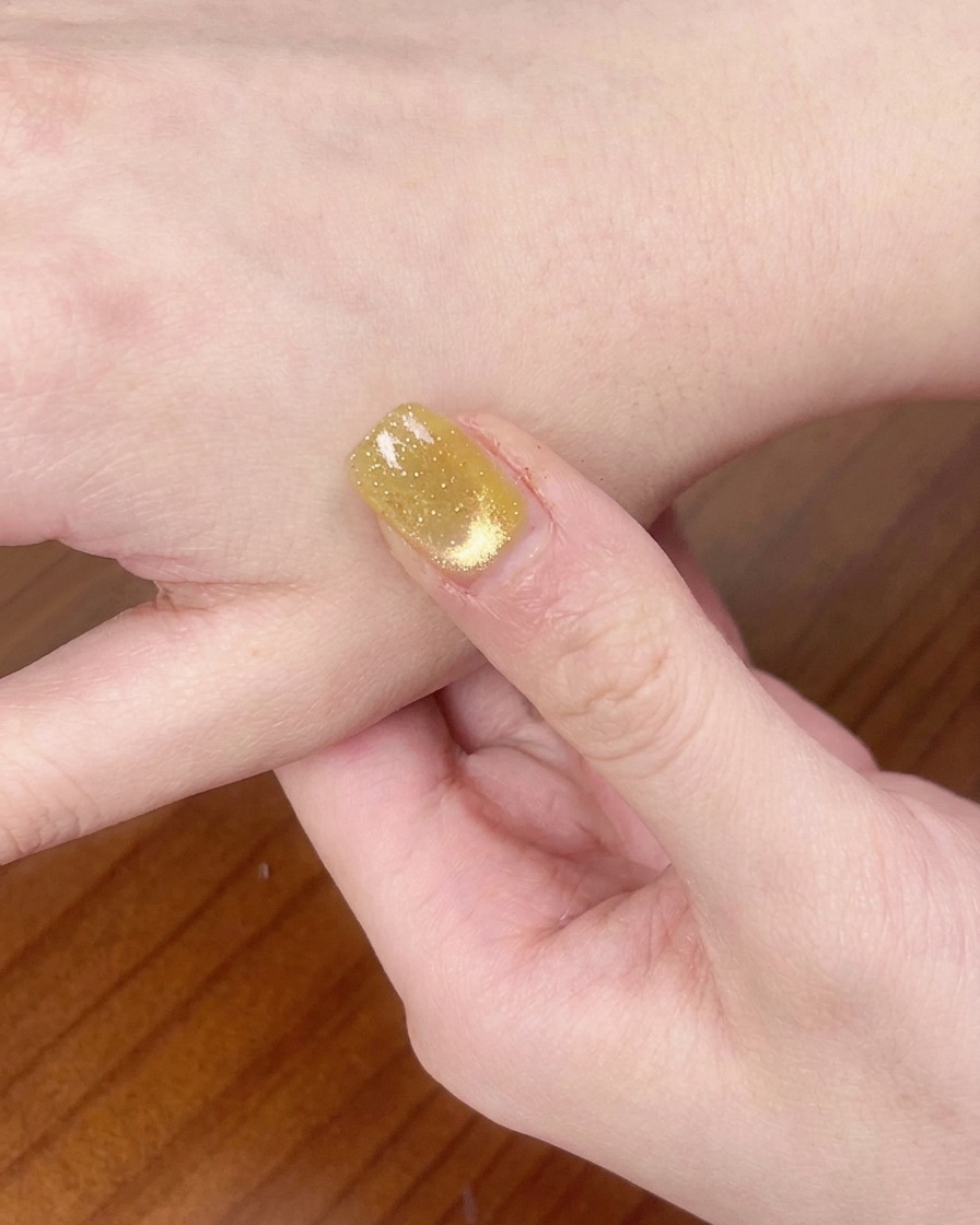 Eine Hand in einer UV/LED-Nagellampe zum Aushärten des Gels.