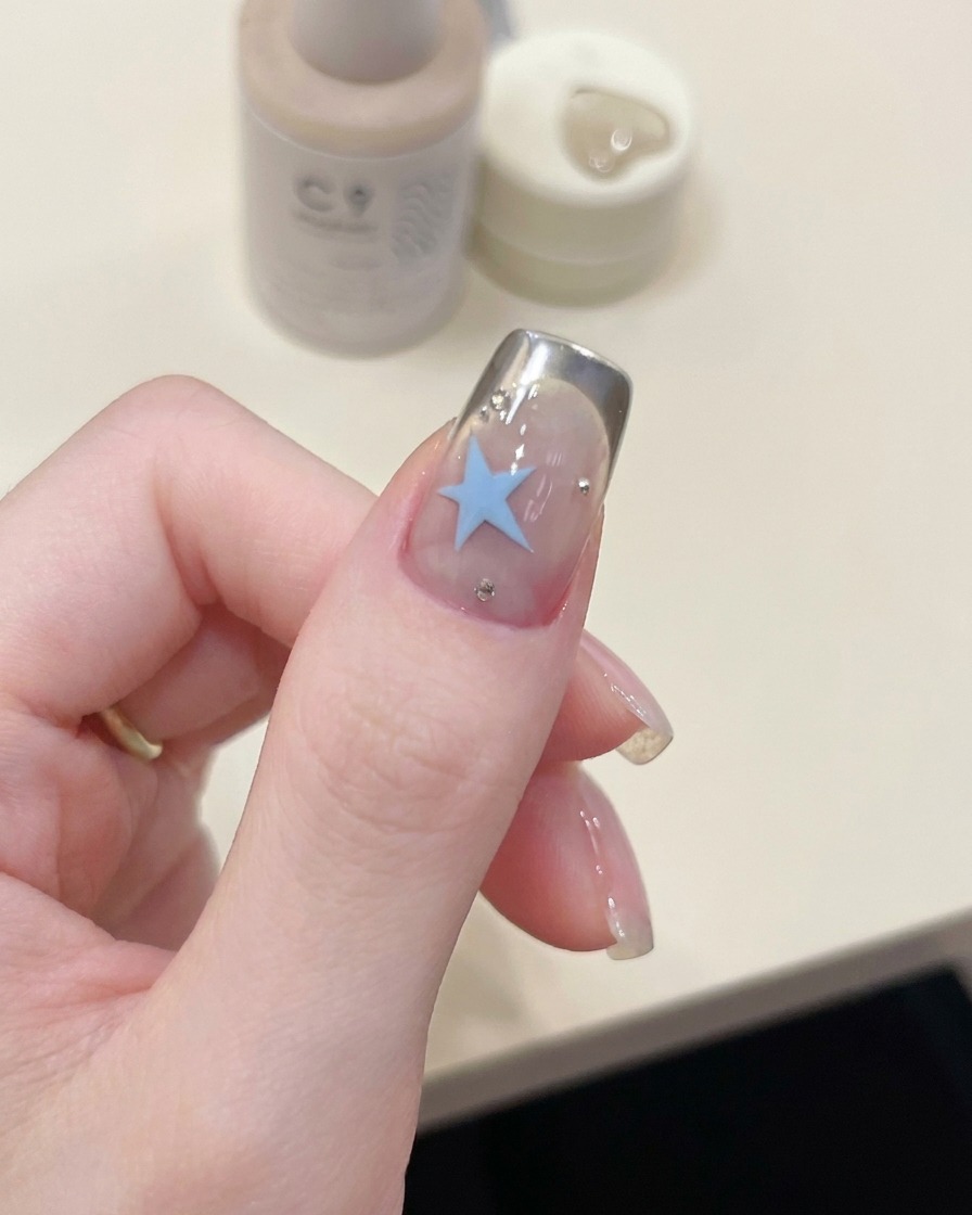 Ein Pinsel trägt eine abschließende Schicht klaren Überlacks über das fertige Design auf.