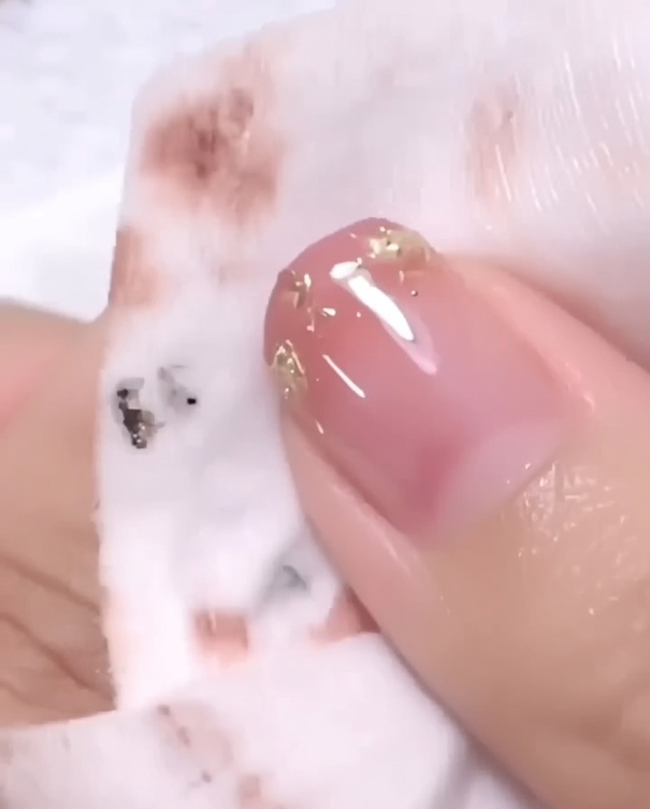 Eine Hand, die für den letzten Aushärtungsprozess in einer UV/LED-Nagellampe liegt.