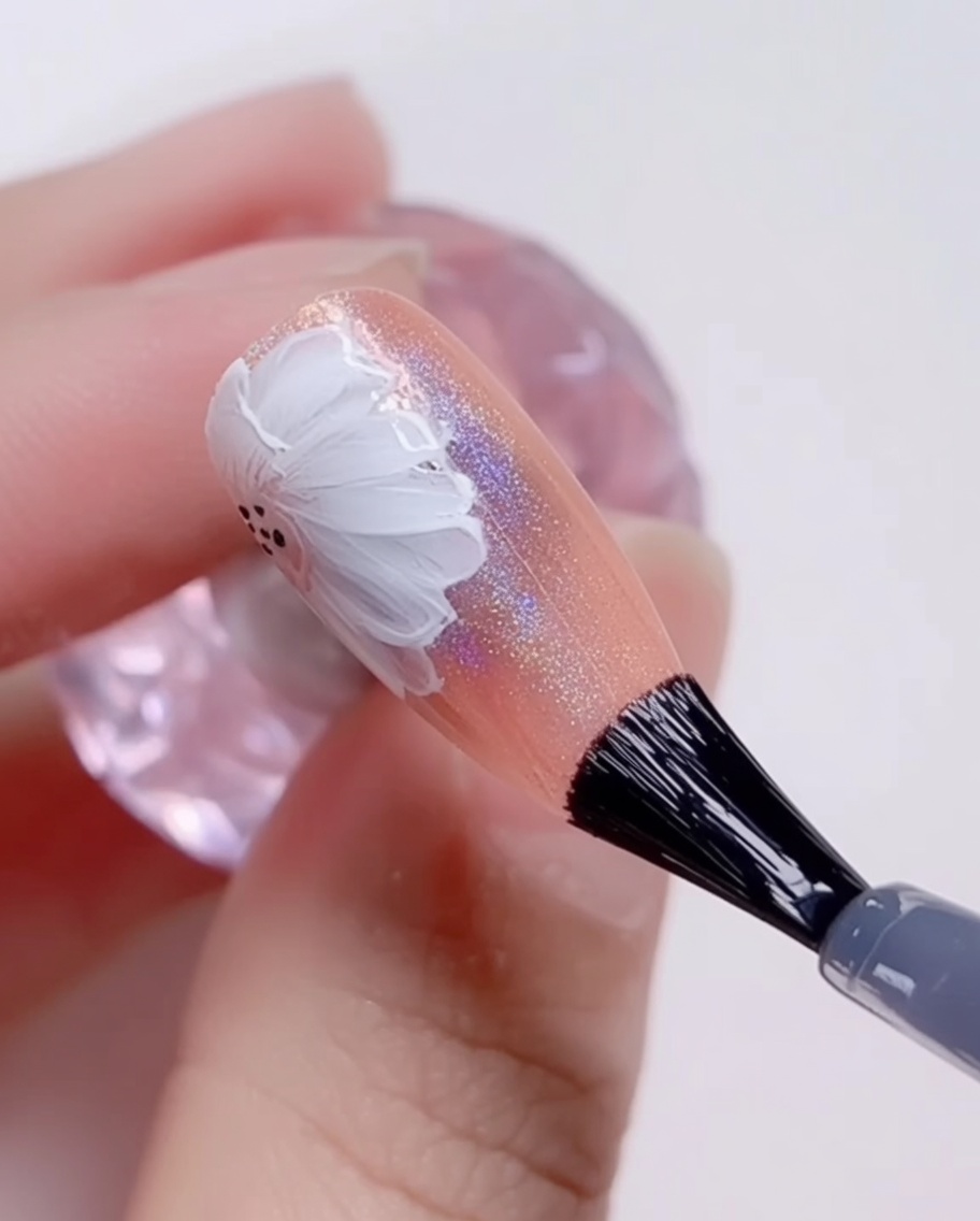 Ein Pinsel trägt den finalen glänzenden Top Coat über das fertige Design auf.