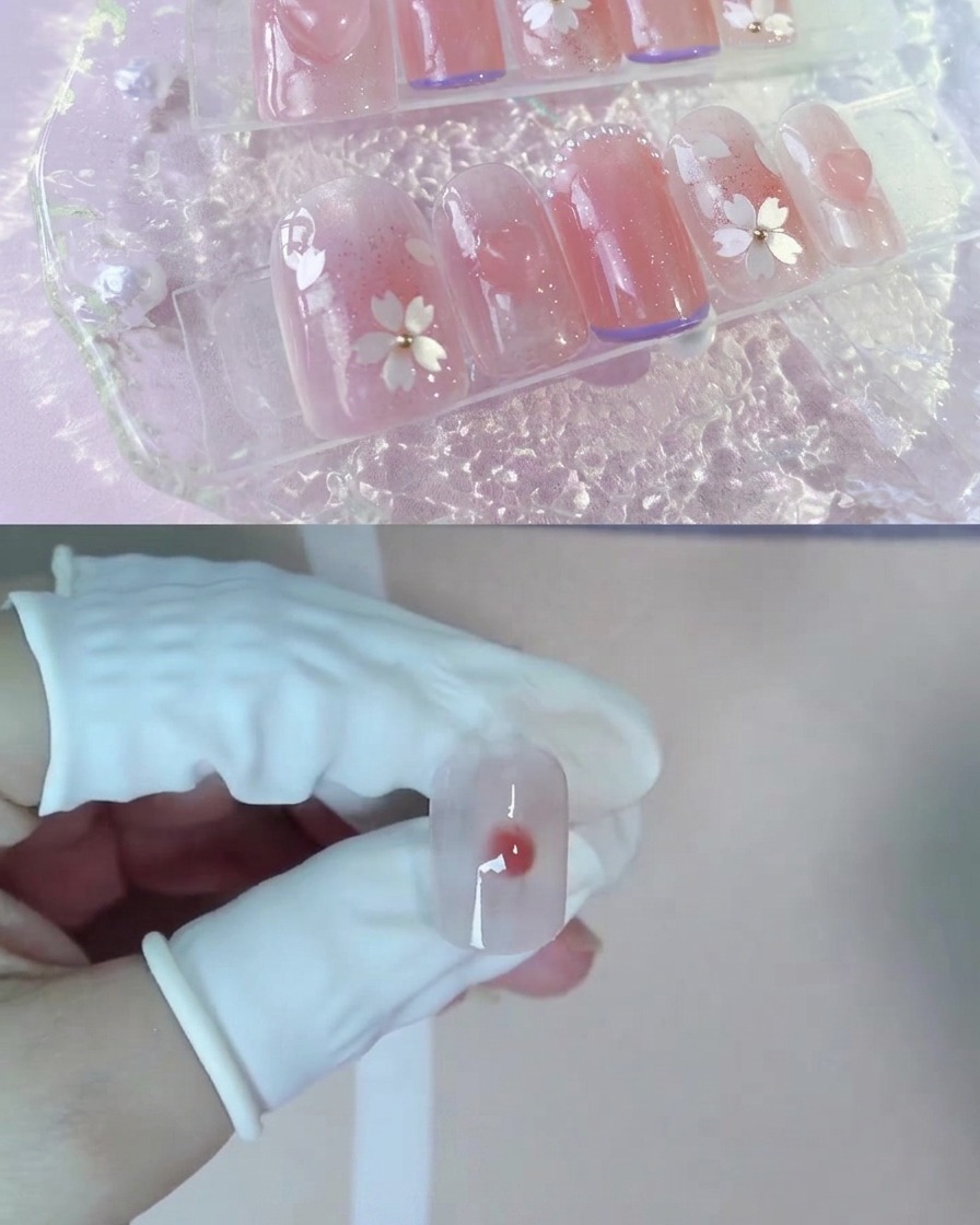 Ein Tropfen dunkleres Pfirsich-Nude-Gel ruht in der Mitte des nassen Blooming-Gels auf einem Nagel.