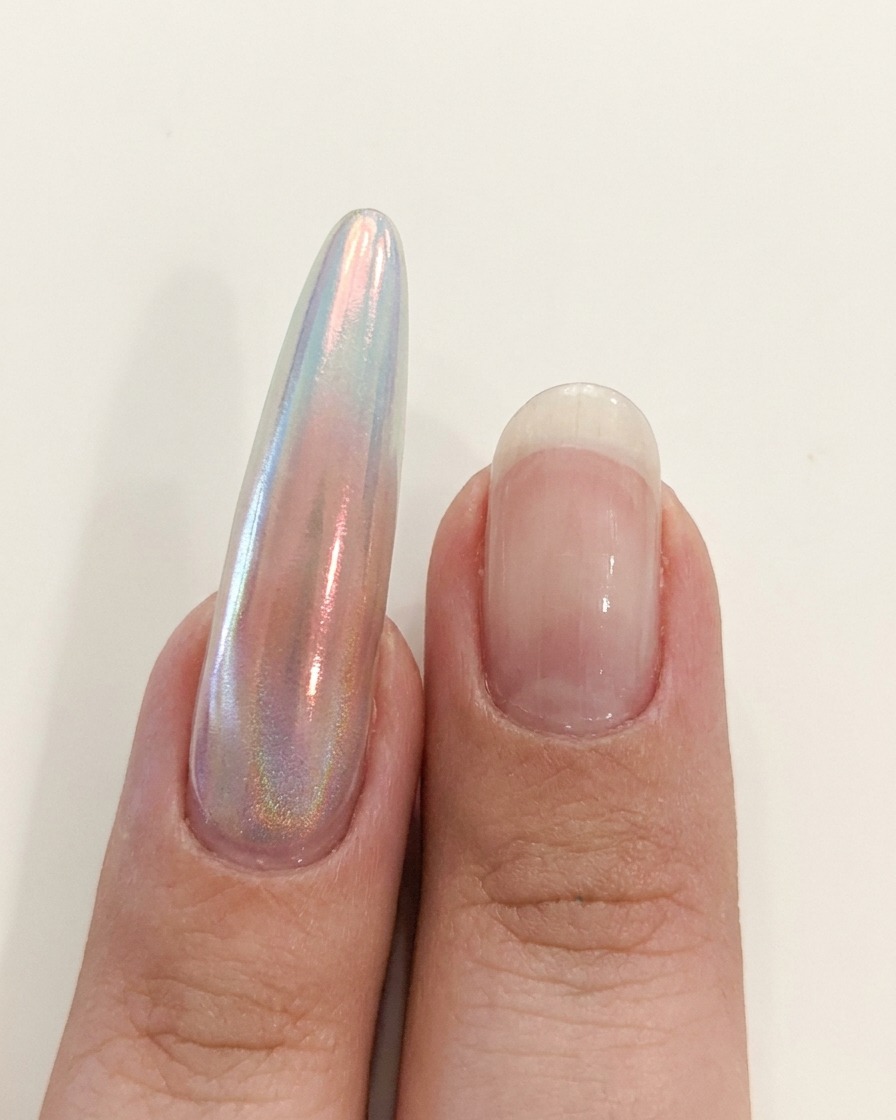 Eine Hand positioniert sich nahe einer UV/LED-Lampe, um die Nagelapplikation auszuhärten.