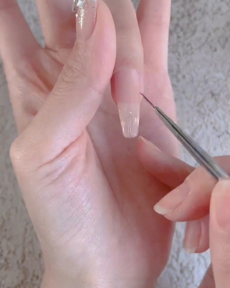 Ein Finger mit einer klaren Gelschicht wird unter einer professionellen UV- oder LED-Nagellampe ausgehärtet.
