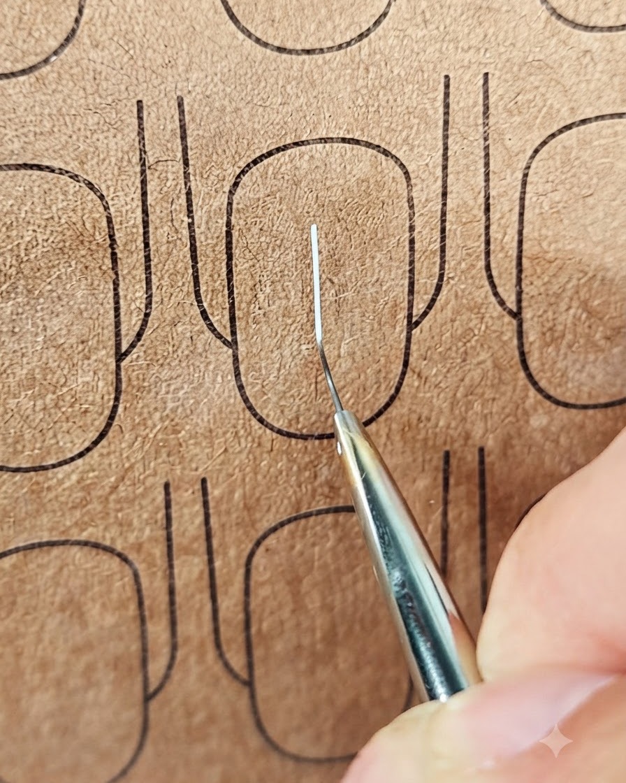 Eine Nahaufnahme eines Liner-Pinsels, der eine horizontale weiße Linie über eine vertikale Linie auf einer Übungsnageloberfläche zieht.