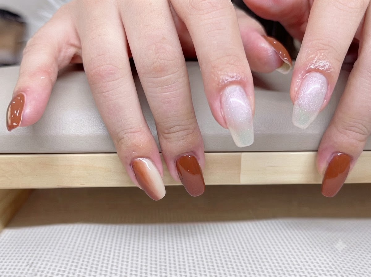Nahaufnahme von Händen mit aufgetragenem milchweißem transluzenten Base Coat auf Zeige- und Mittelfinger.