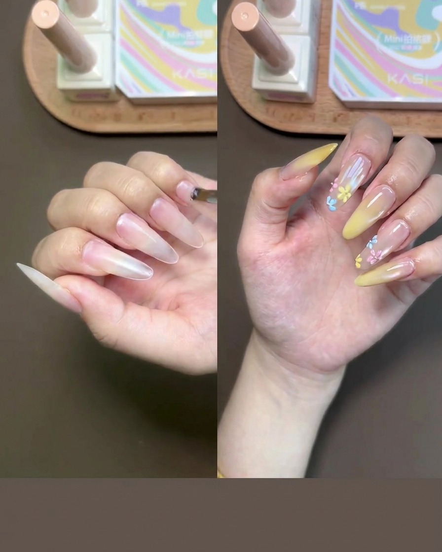Nahaufnahme einer Hand, bei der mit einem kleinen Pinsel Nude Base-Gel auf die Fingernägel aufgetragen wird.