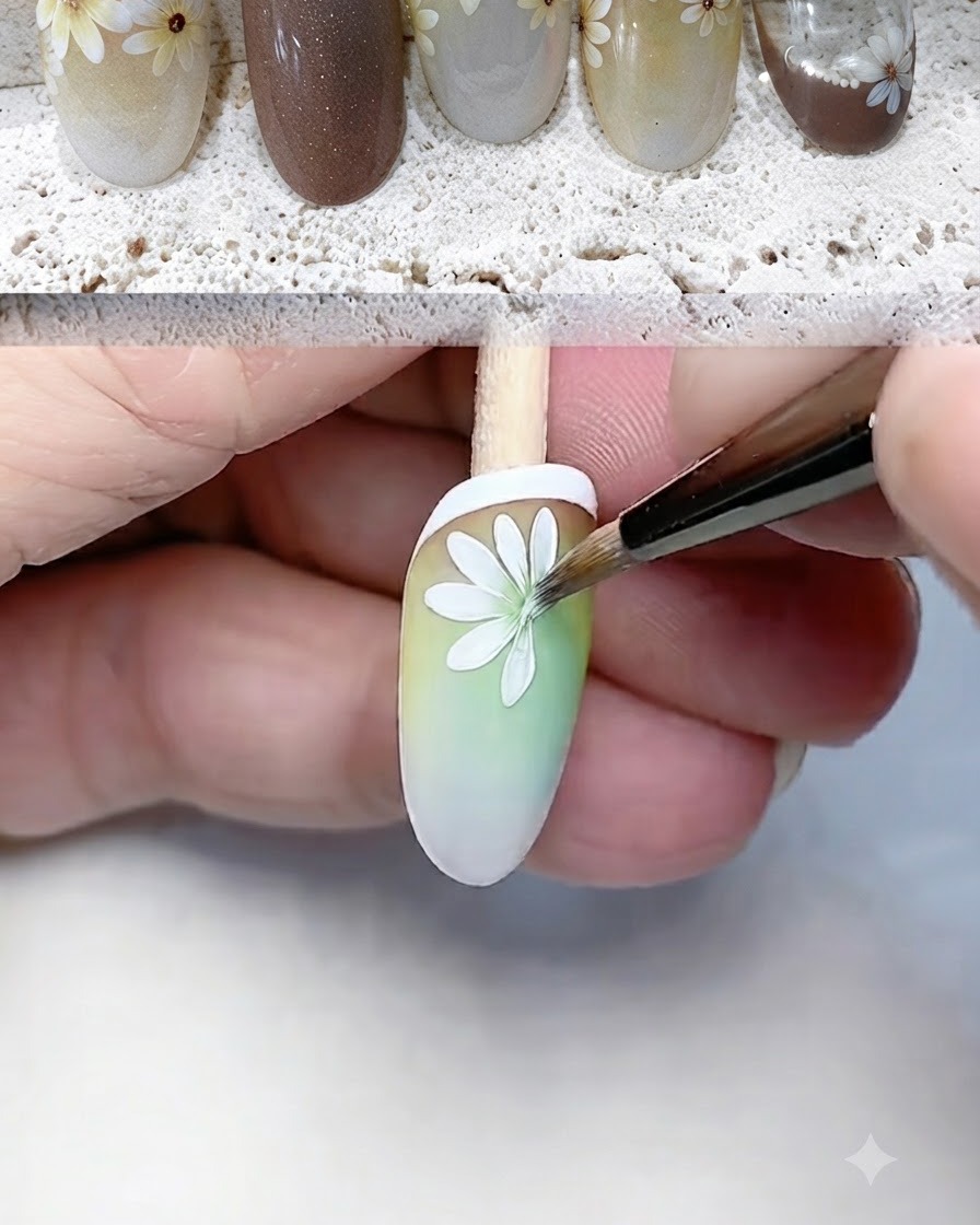 Ein feiner Liner-Pinsel malt und definiert sorgfältig weiße Gänseblümchenblätter auf einer Nagelspitze mit Farbverlauf.