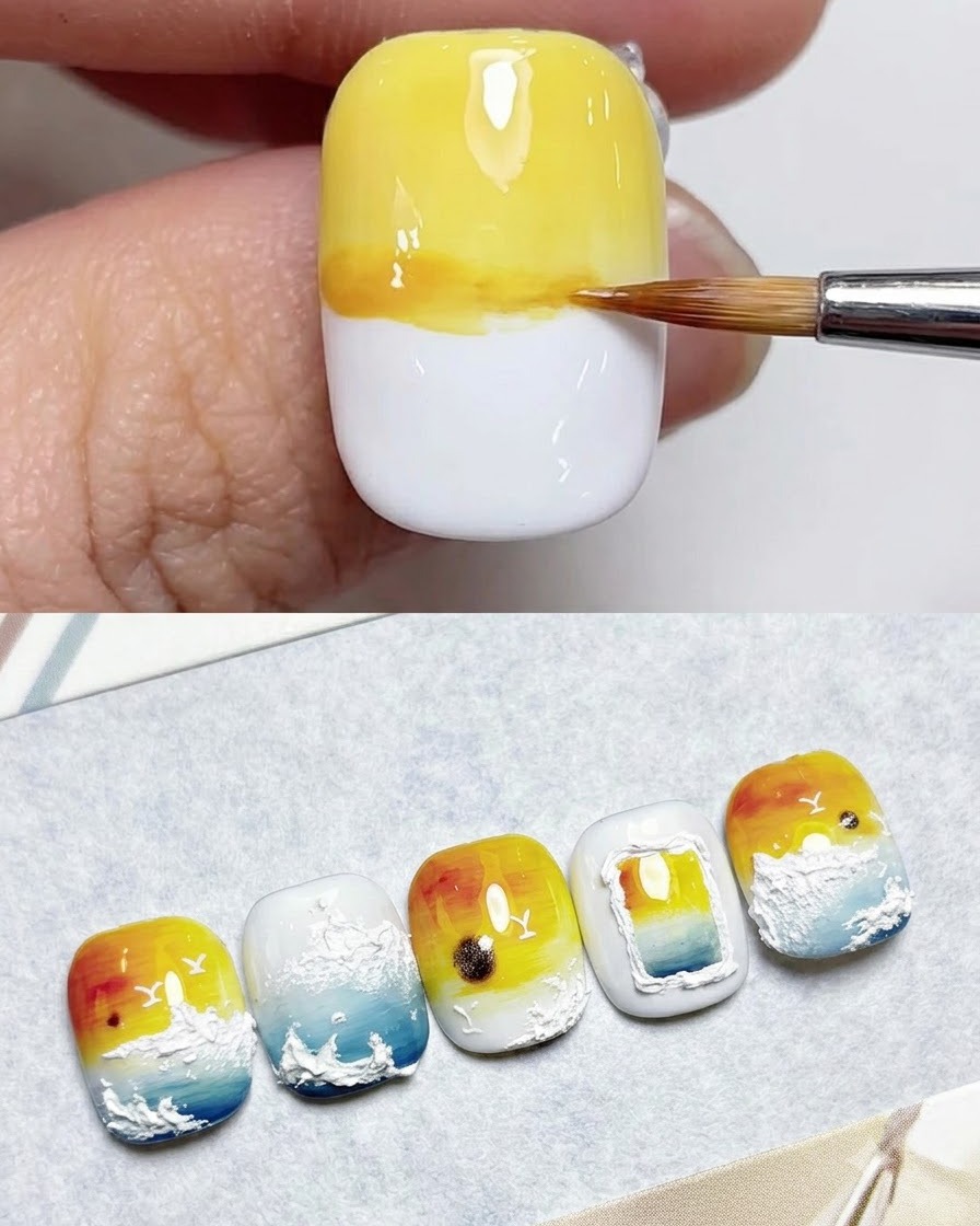 Ein Fächerpinsel verblendet blasses Gelbgel über den oberen Teil eines weißen Nagels.