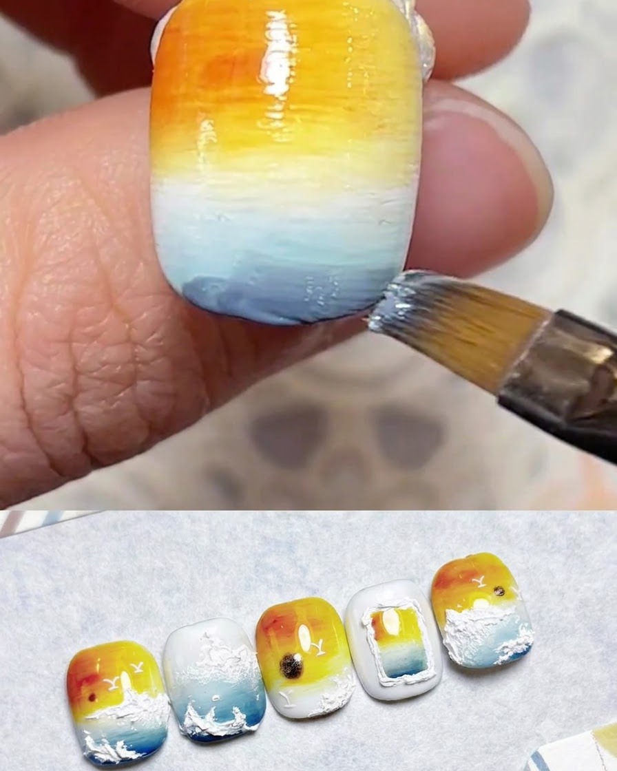 Ein Pinsel verblendet blaue Gelschichten im unteren Abschnitt des Nagels.