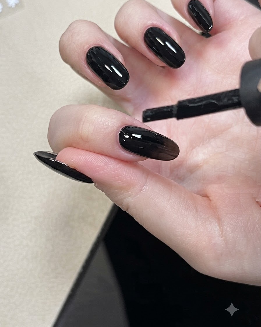 Ein Nagelpinsel trägt Nude Basisschicht-Gel auf einen Fingernagel auf.