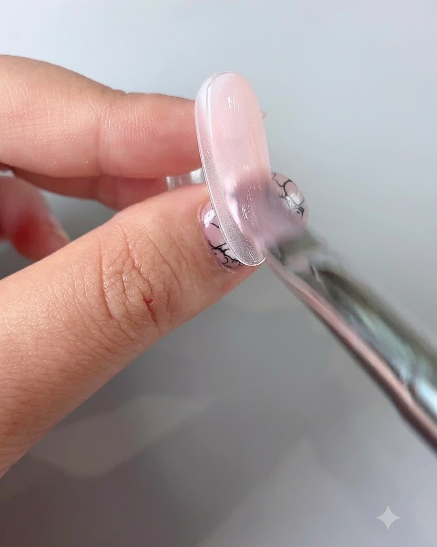 Ein feiner Linienpinsel, der zarte dünne Linien auf einen gelackten Nagel zeichnet.