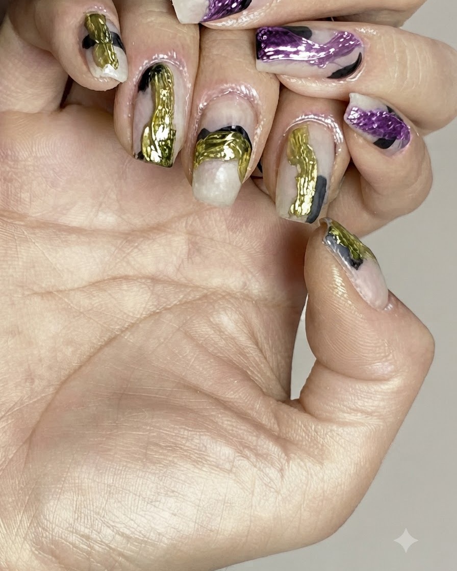 Ein Pinsel trägt einen klaren Glanz-Top-Coat über fertige abstrakte Nail-Art auf.