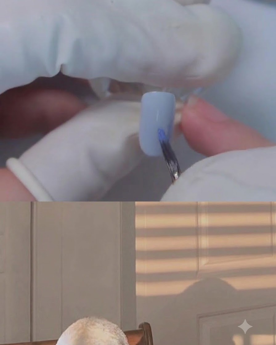 Ein feiner Pinsel, der Farbe auf den Nagel des kleinen Fingers mit Blooming-Gel aufträgt.