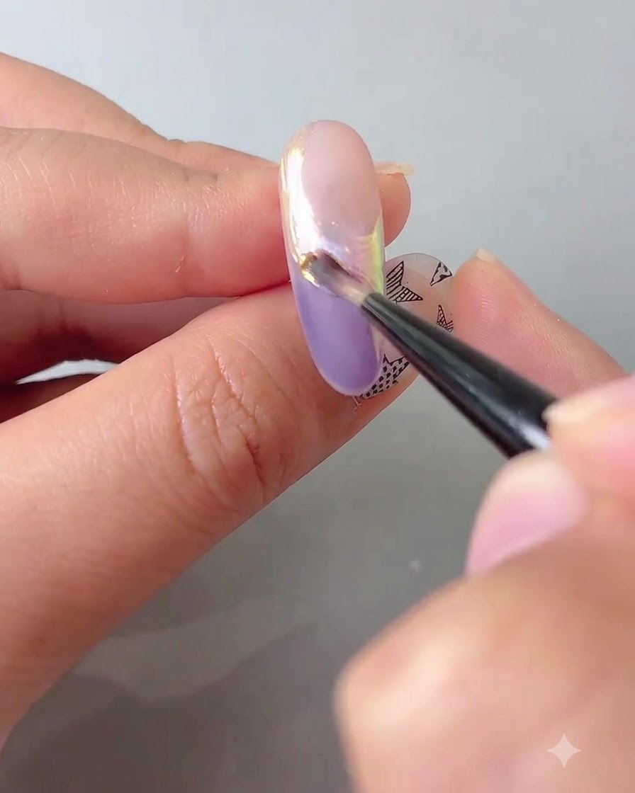 Ein Nagelpinsel, der eine Schicht klaren Überlacks aufträgt, um das Chrompuder auf einem Nagel zu versiegeln.