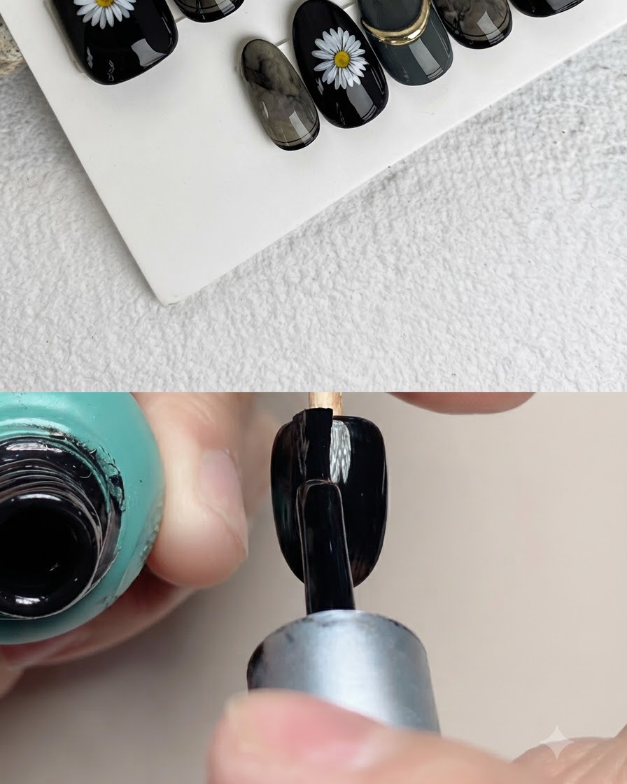 Nahaufnahme eines Nagelpinsels, der weiße Blütenblätter auf eine schwarze Kunstnageloberfläche malt.