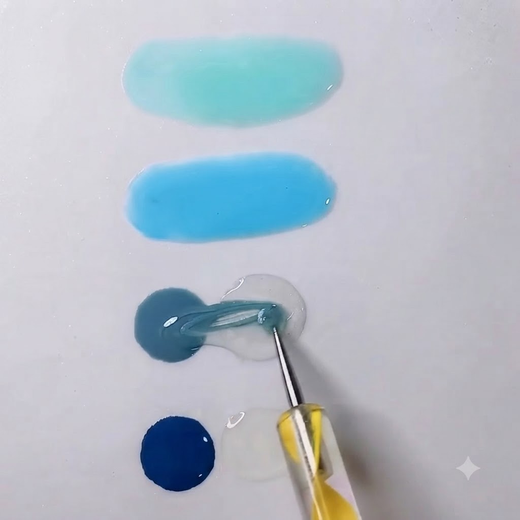 Ein Mischwerkzeug zieht graues Gel in einen benachbarten Tropfen transparentes Gel auf einer weißen Palette.