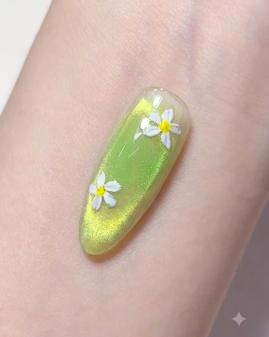 Ein feiner Liner-Pinsel nimmt einen Tropfen klaren Aufbaugel über einem grünen Nagel auf.